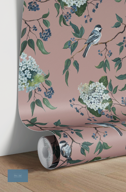 Roll of wallpaper with floral and bird design on a pink background