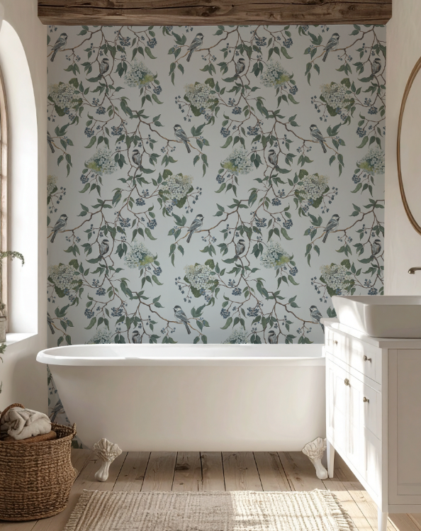 Bathroom with floral wallpaper, white bathtub, and wooden floor.