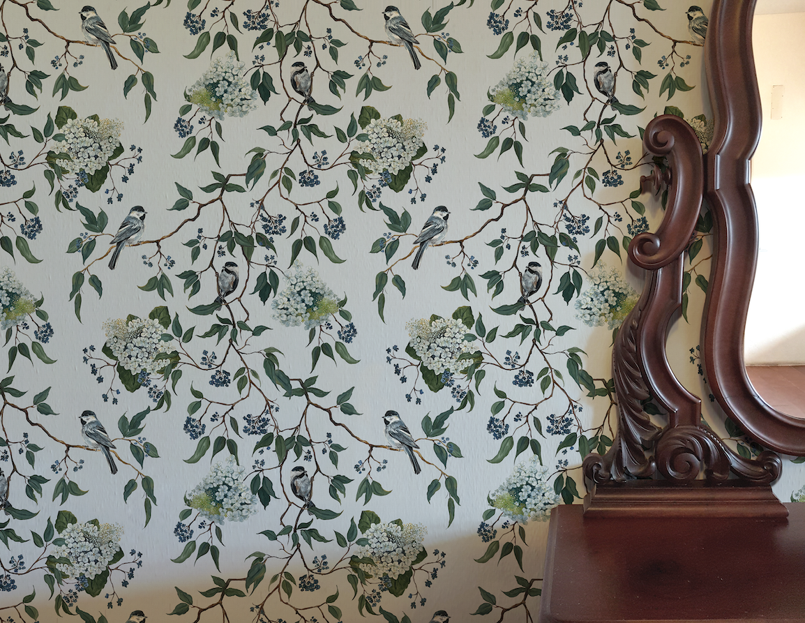 Wallpaper with floral and bird pattern next to a wooden mirror