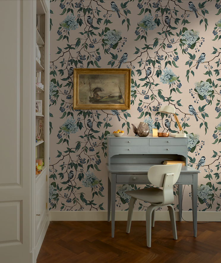 Room with floral wallpaper, desk, and chair.