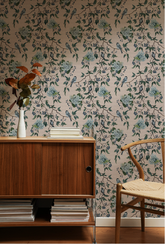 Room interior with floral wallpaper, wooden cabinet, and chair.
