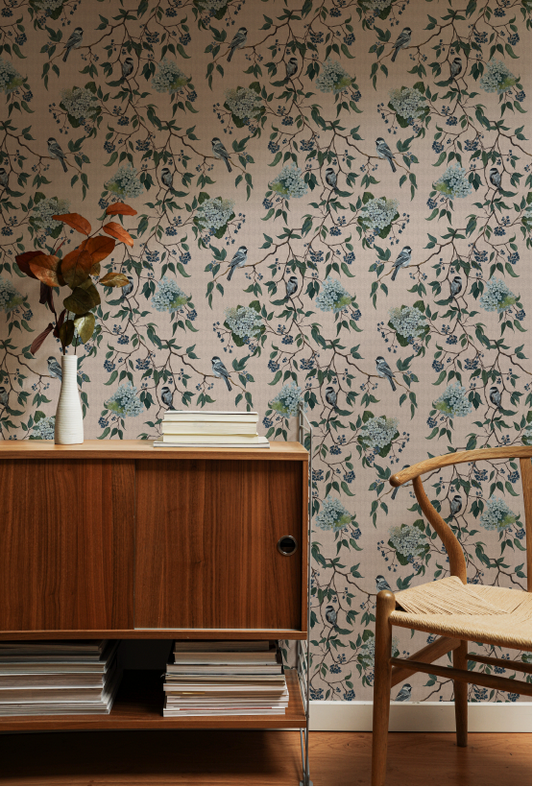Room interior with floral wallpaper, wooden cabinet, and chair.
