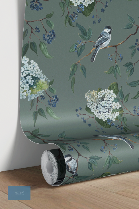 Roll of wallpaper with floral and bird design on a green background