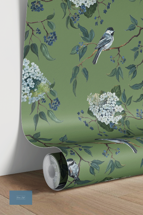 Roll of wallpaper with floral and bird design on a green background