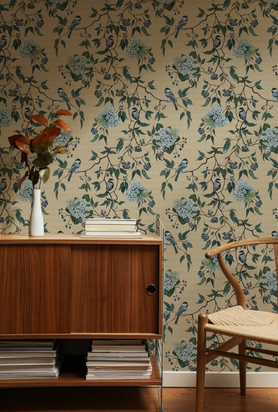 Room interior with floral wallpaper, wooden cabinet, and chair.