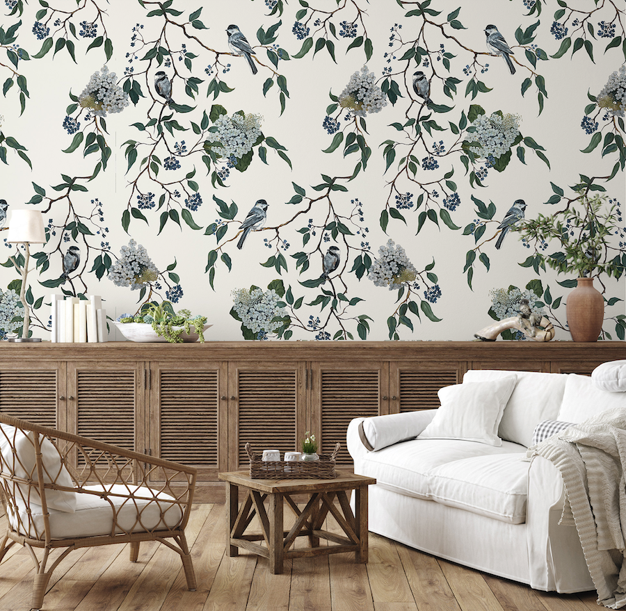 Living room with floral wallpaper, white sofa, and wooden furniture.