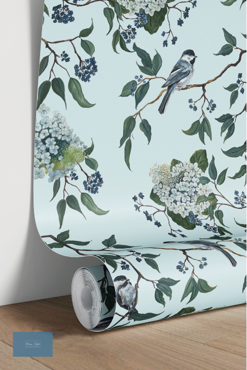 Roll of wallpaper with floral and bird design on a light blue background