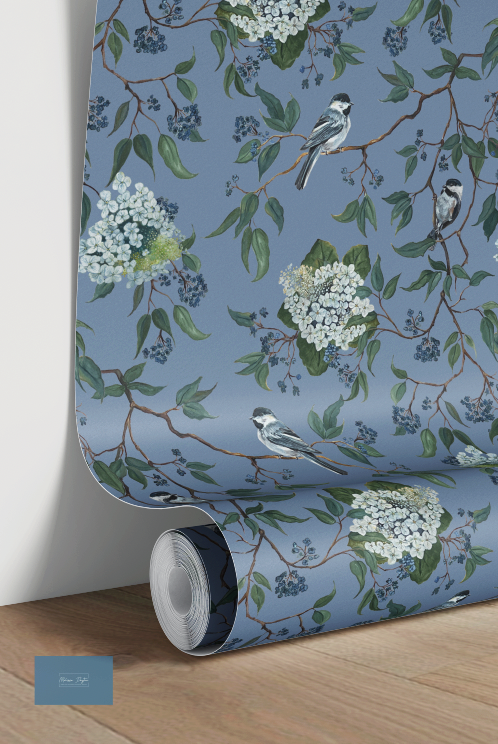 Roll of wallpaper with floral and bird design on a blue background