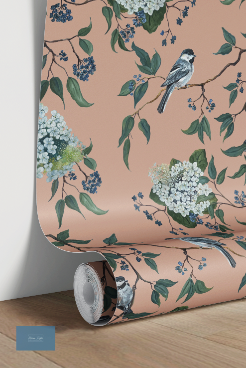 Roll of wallpaper with floral and bird design on a peach background