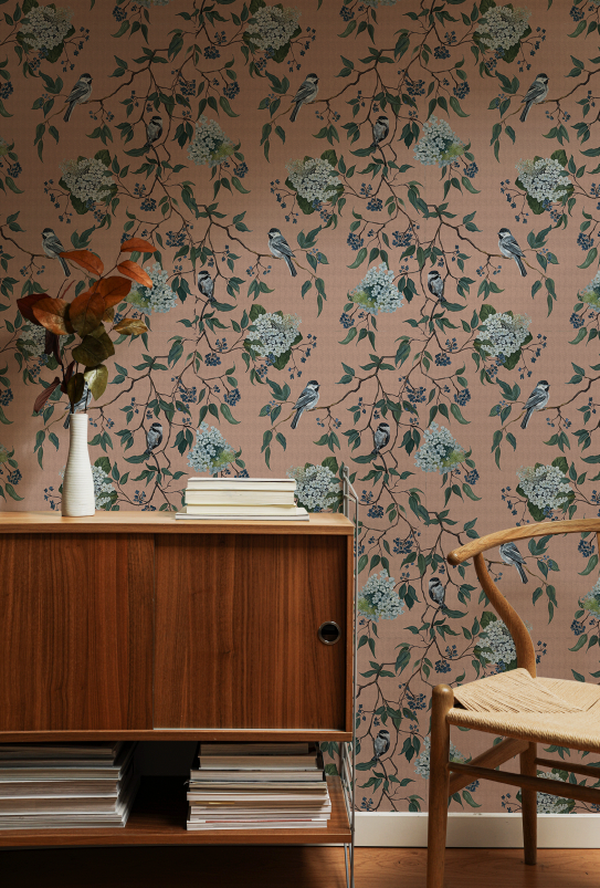 Room interior with floral wallpaper, wooden cabinet, and chair.
