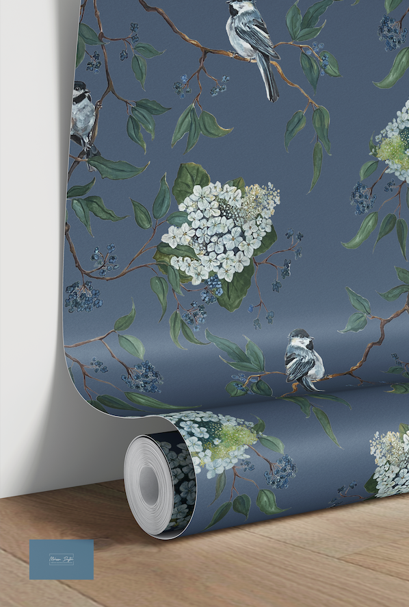 Roll of wallpaper with floral and bird design on a blue background