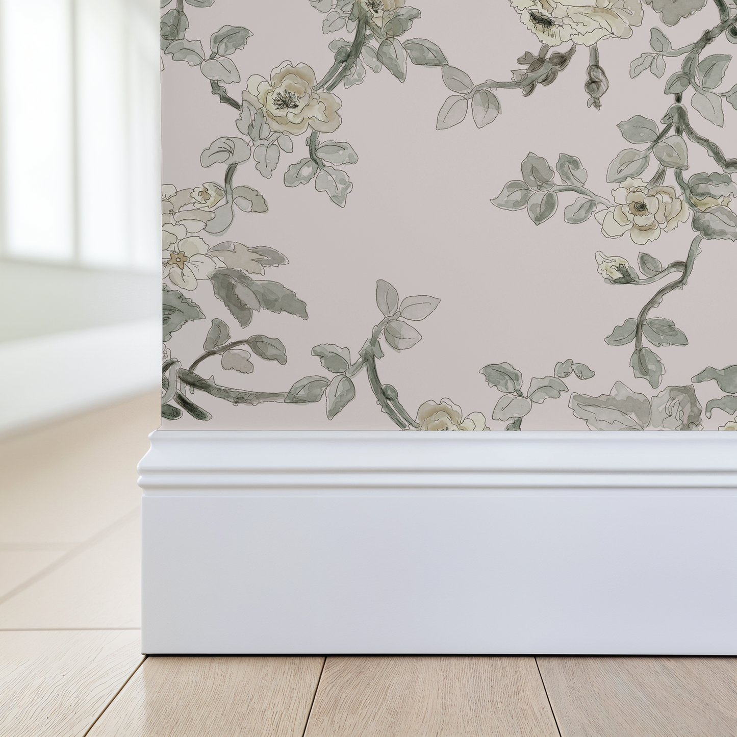 Floral wallpaper with green leaves and beige flowers on a light pink background, applied to a wall.