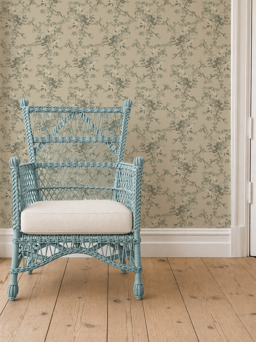Trailing roses in tea stain warm beige wallpaper mock_up_blue_wicker_with_cushion_carm