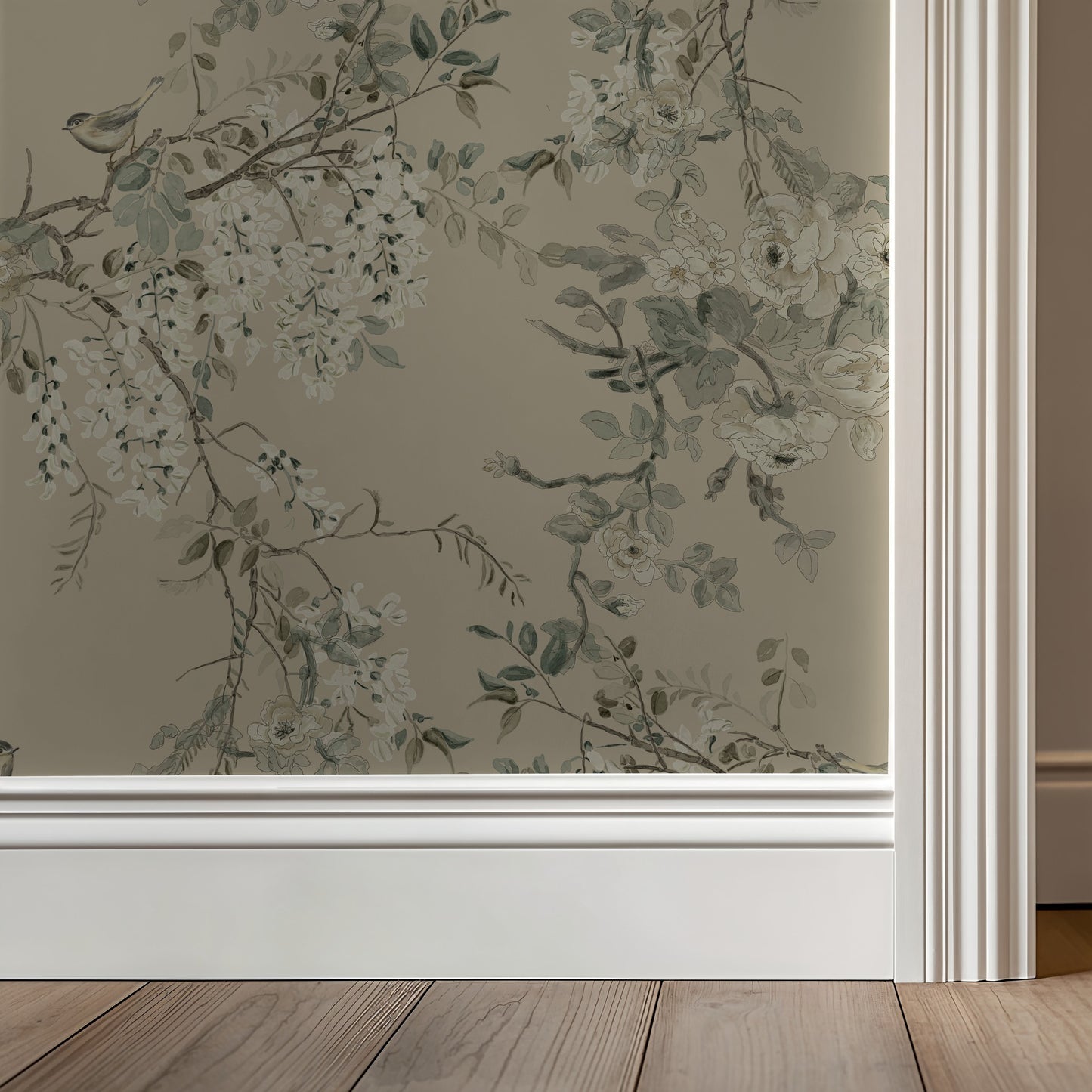 Floral wallpaper with greenery on a neutral wall with wooden flooring.