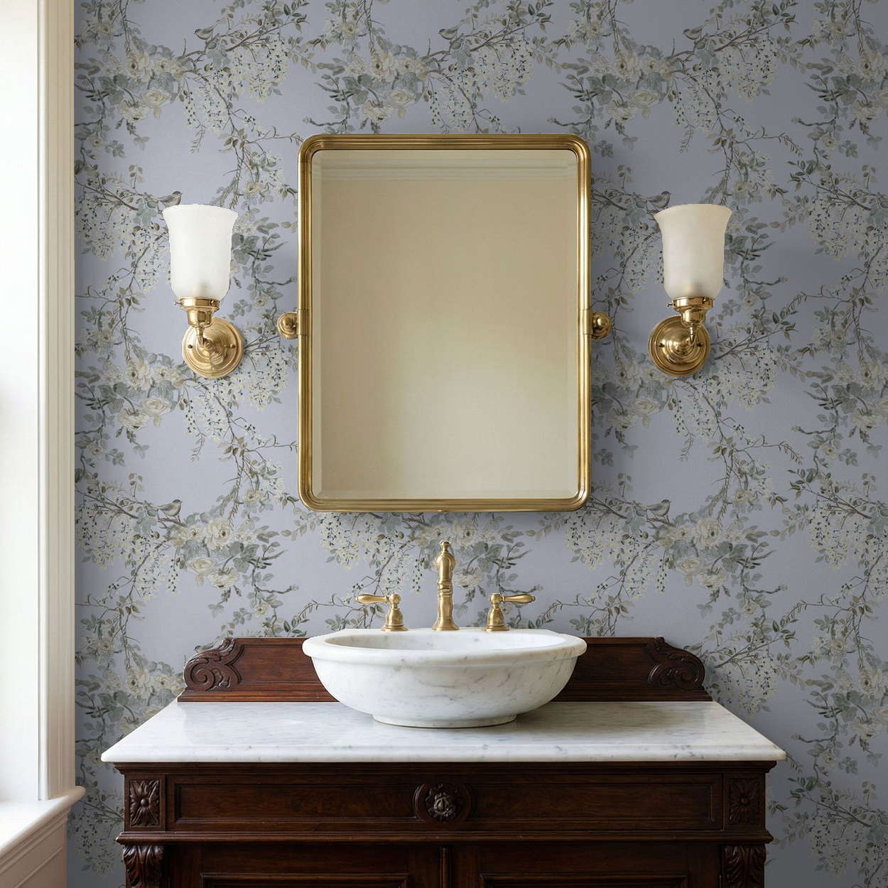 Bathroom vanity with marble sink, gold fixtures, and wall-mounted mirror against floral wallpaper.