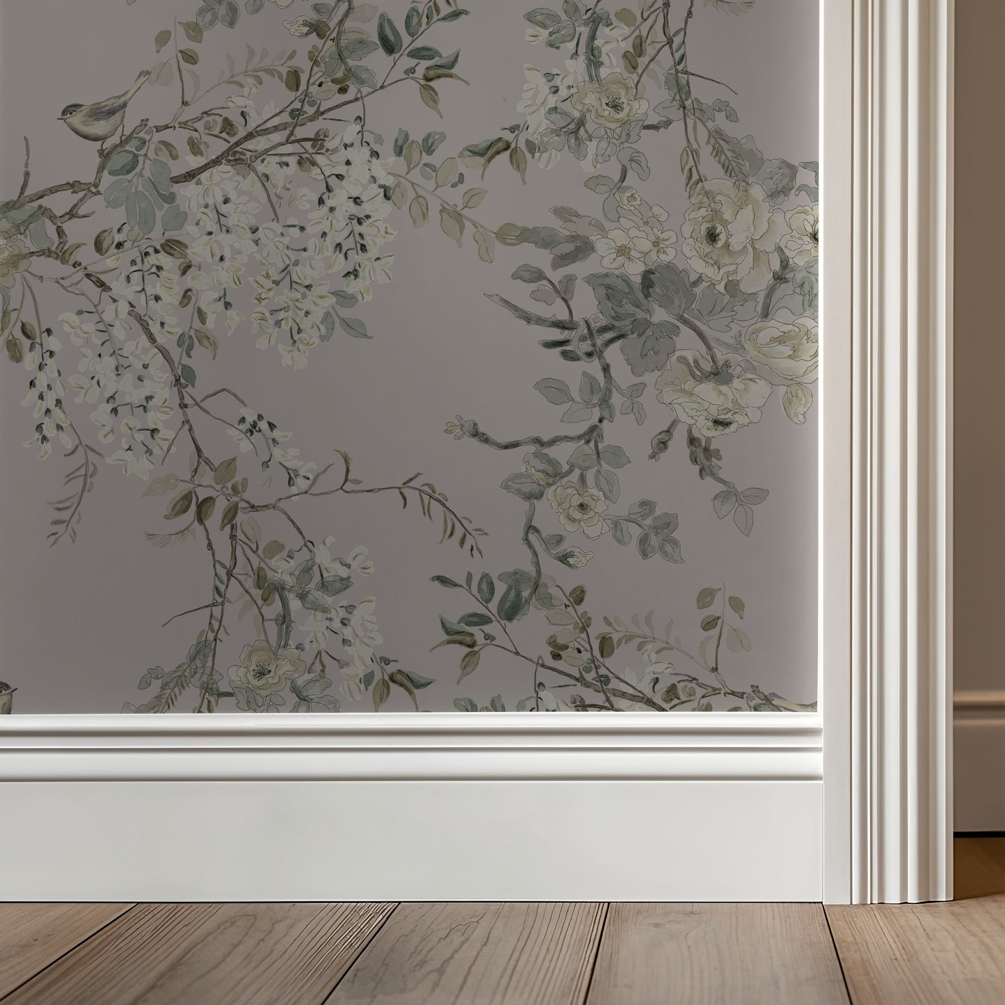 Floral wallpaper with greenery on a neutral wall with wooden flooring.