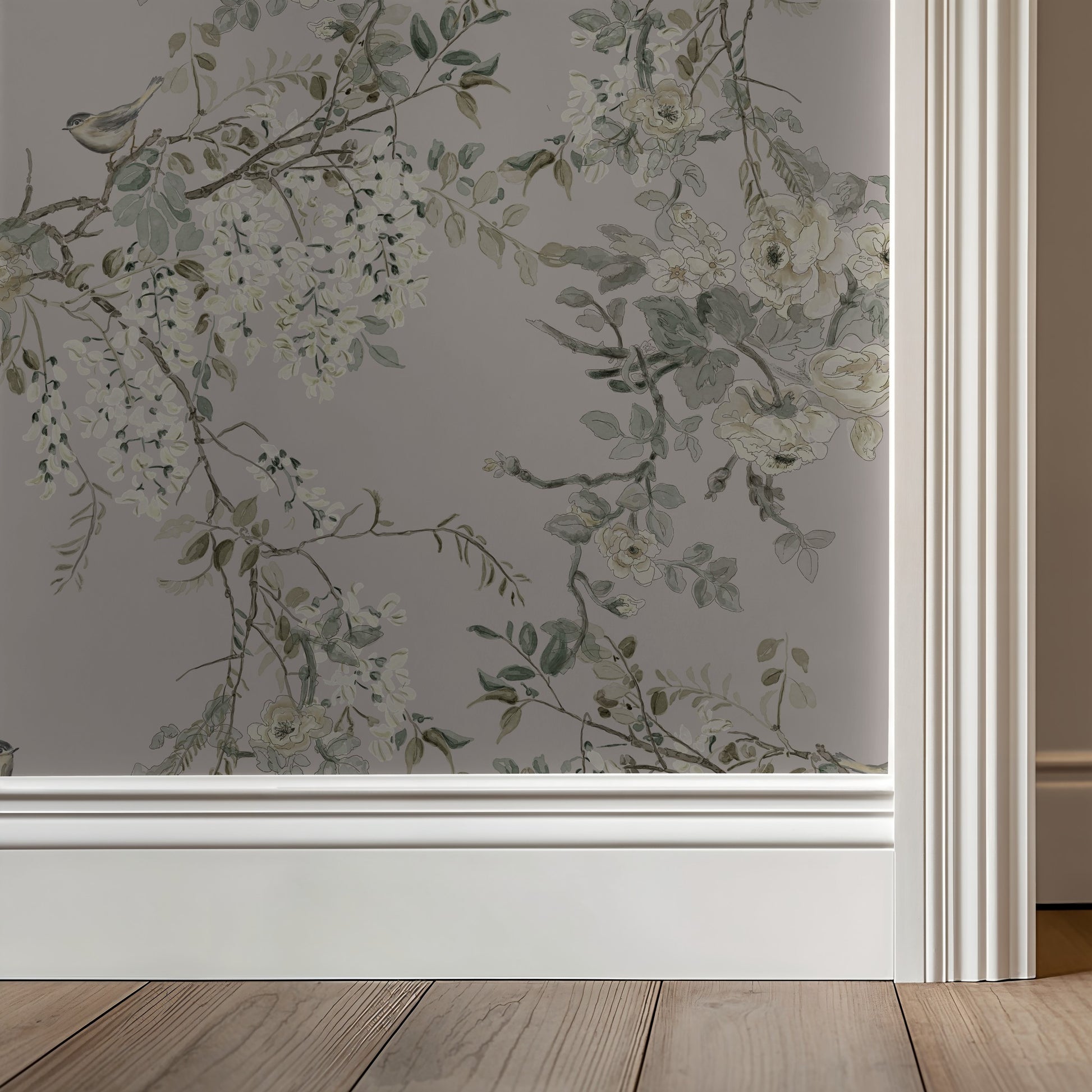 Floral wallpaper with greenery on a neutral wall with wooden flooring.