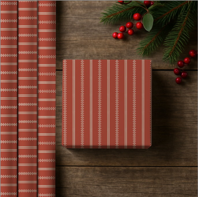 Red and white striped gift wrap on a wooden surface with Christmas decorations.