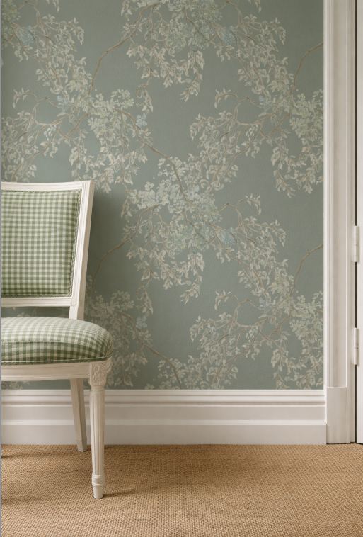 Floral wallpaper with a checkered chair in the foreground