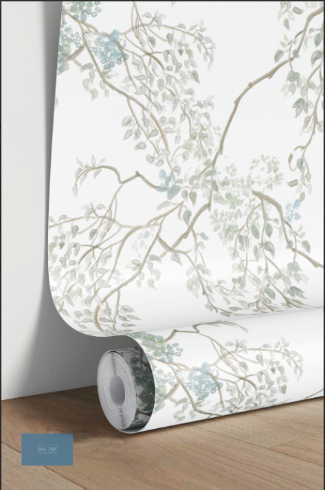 Roll of floral wallpaper on a wooden floor with a white wall background