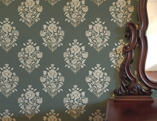 Floral wallpaper with a wooden mirror on a dark green background