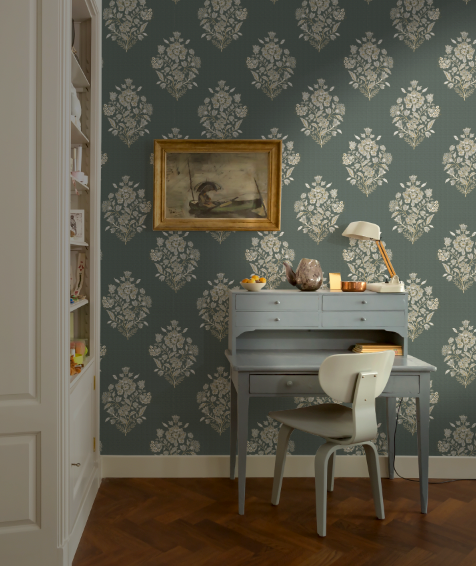 Room with floral wallpaper, desk, and chair.