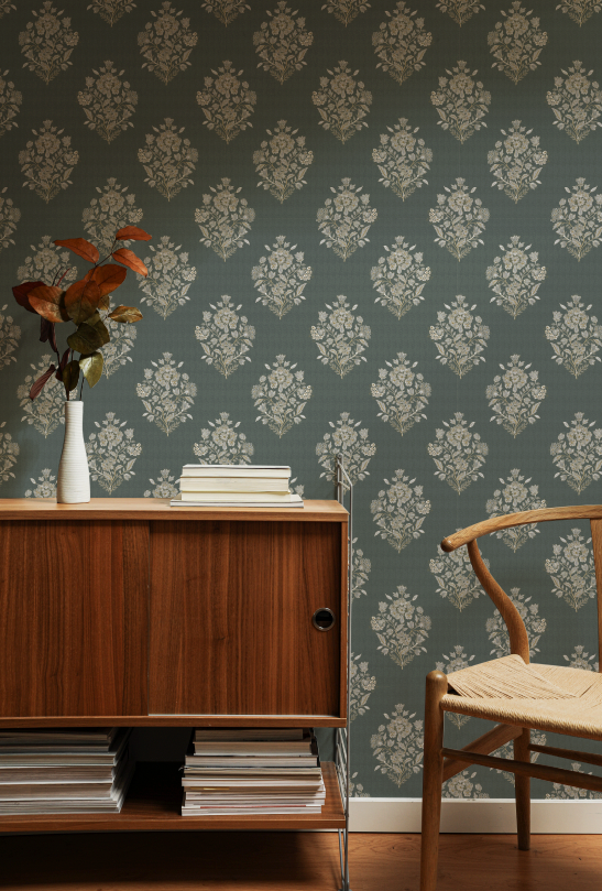 Room interior with wooden furniture and chair against a patterned wall.