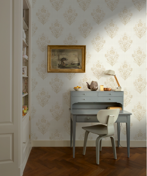 Room interior with a desk, chair, and decorative elements against a patterned wall.