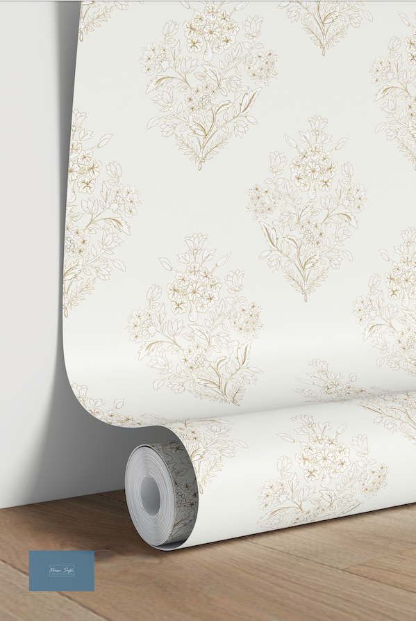 Roll of floral wallpaper on a wooden surface with a light background