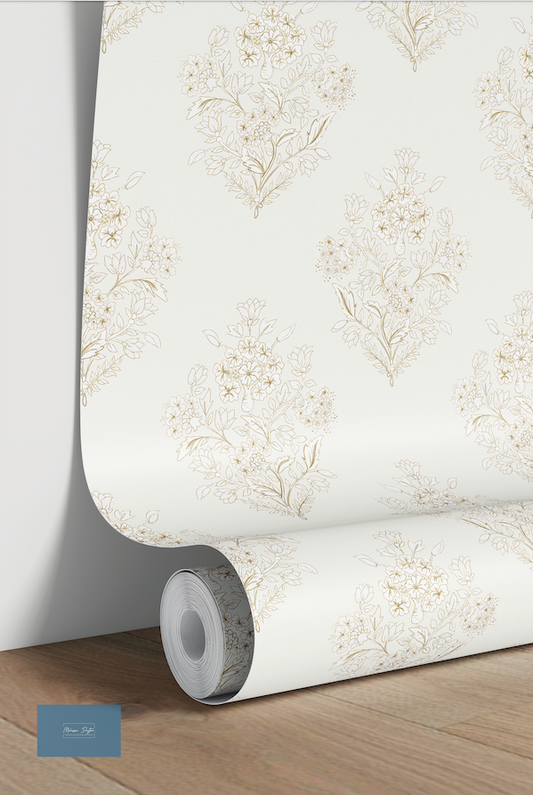 Roll of floral wallpaper on a wooden surface with a light background