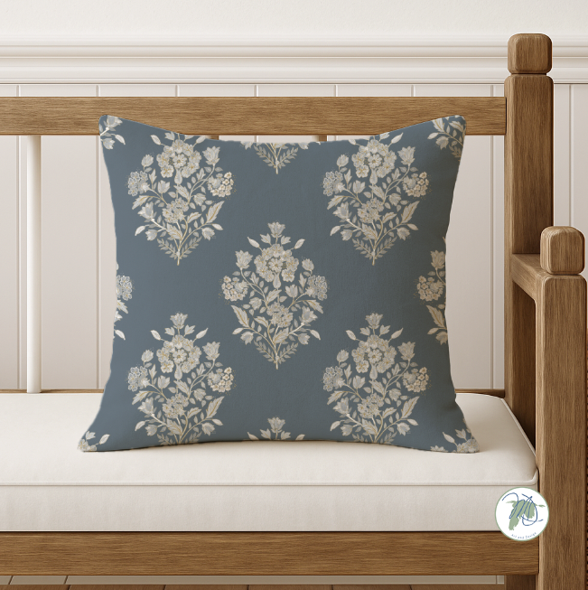 Floral-patterned pillow on a wooden bench with white cushion