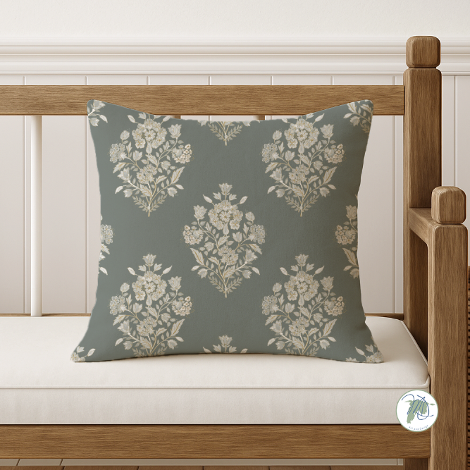 Floral-patterned pillow on a wooden bench with a white background