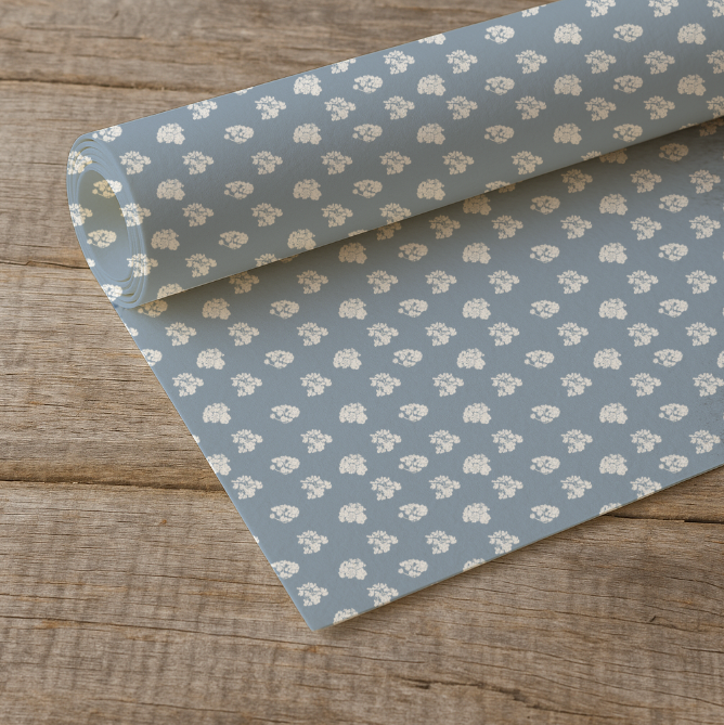 Roll of floral-patterned paper on a wooden surface