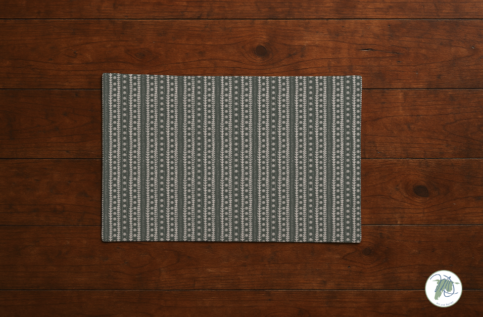 Gray patterned placemat on a wooden surface