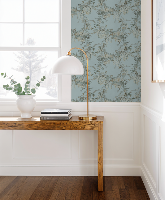 Aqua floral wallpaper with branches in elegant room with wooden table and lamp.