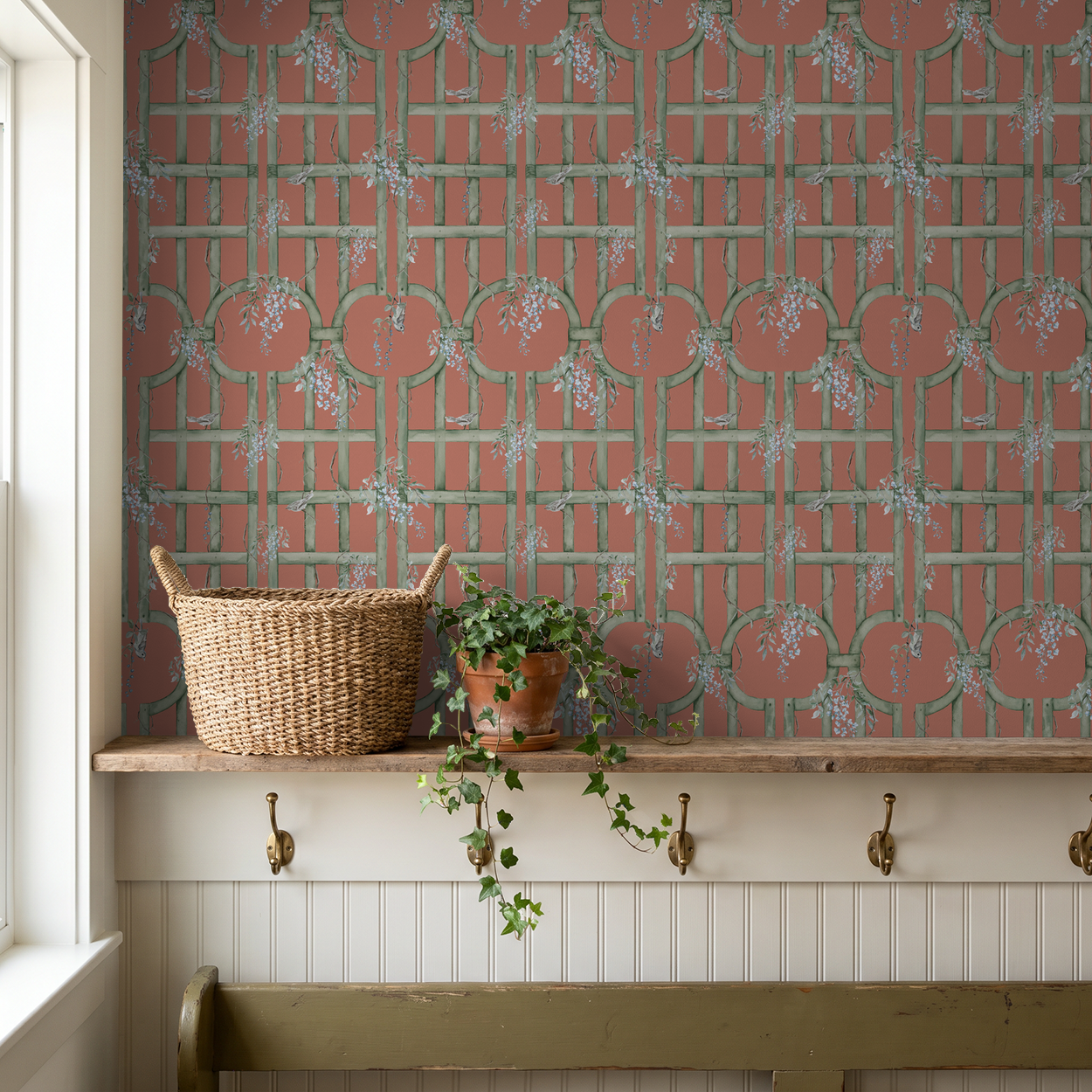 Blood orange wallpaper with green trellis and blue flowers in rustic room setting.