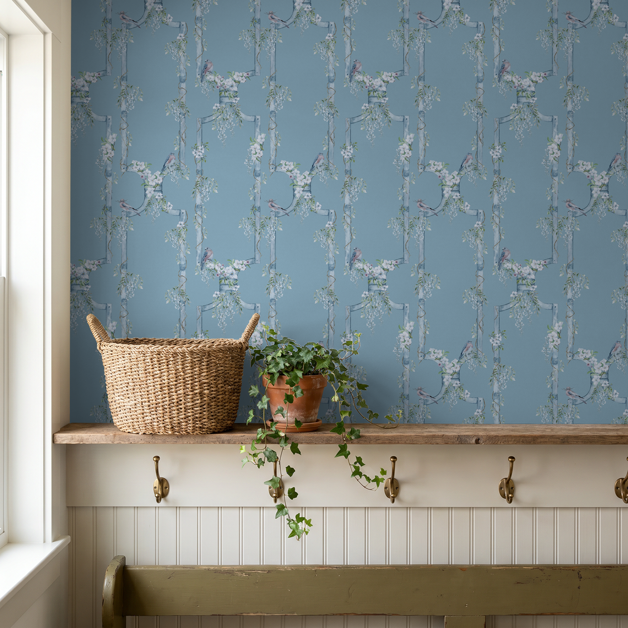 Blue floral wallpaper with birds and vines in rustic room setting.