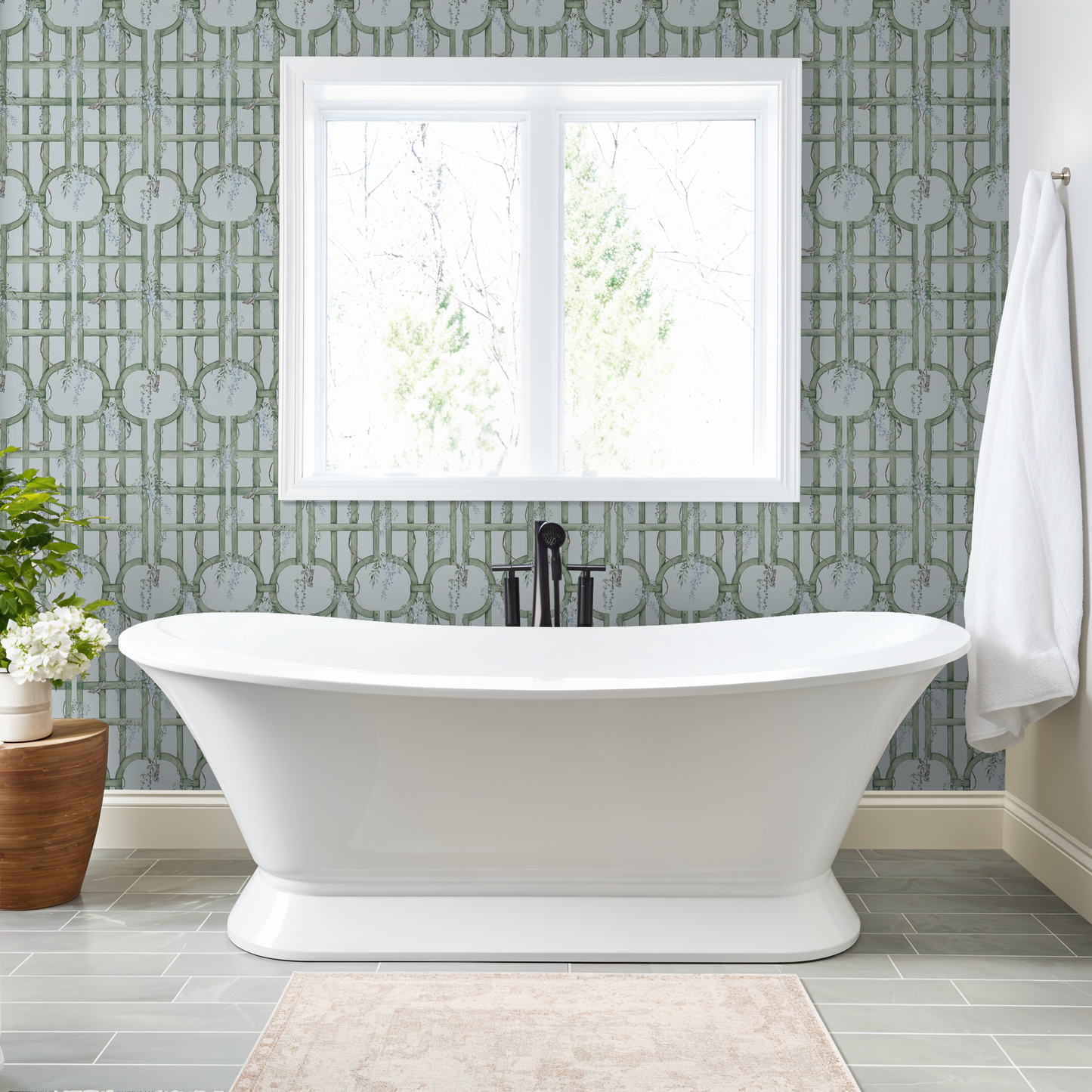 Bathroom with blue and green trellis wallpaper, white bathtub, and window view.