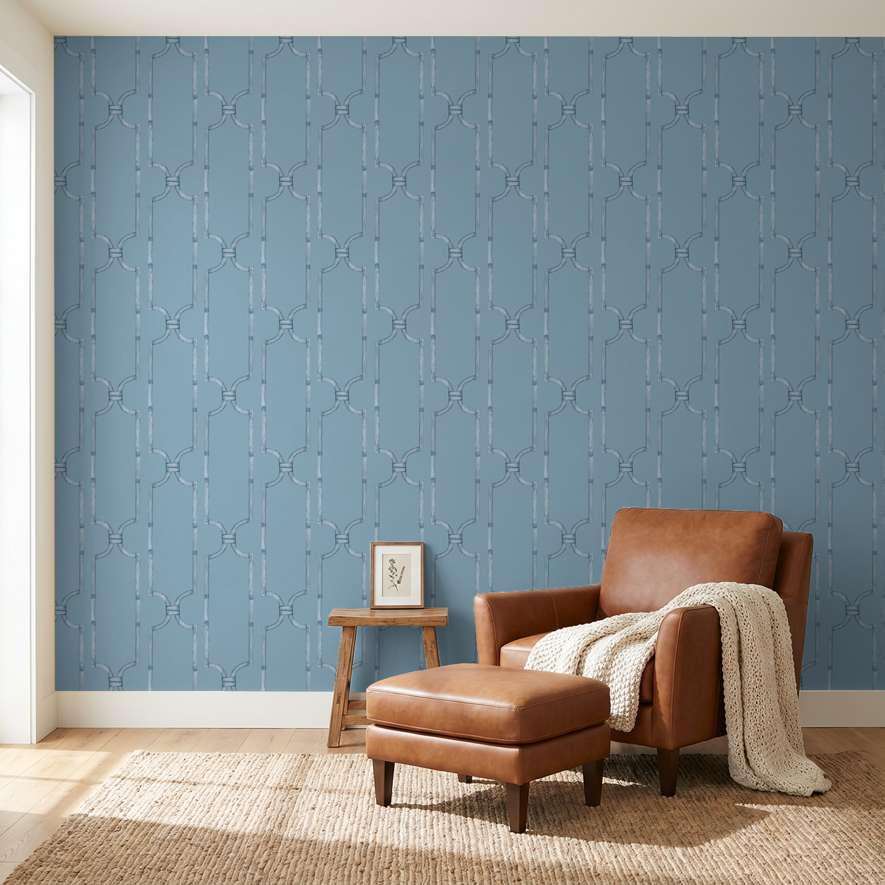 Blue trellis wallpaper in cozy living room with leather chair and ottoman.