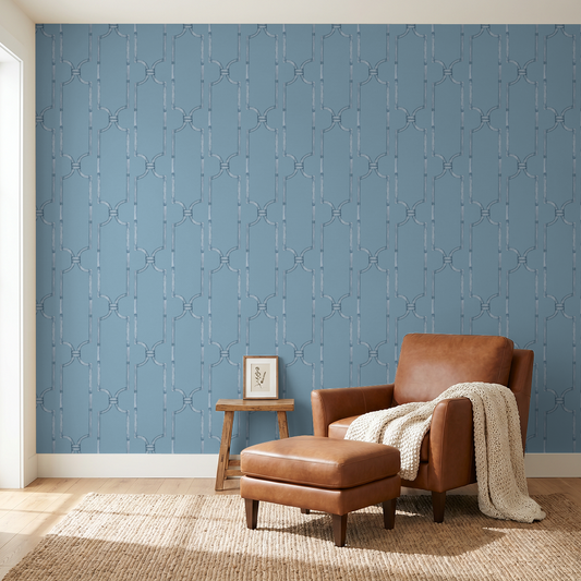 Blue trellis wallpaper in cozy living room with leather chair and ottoman.