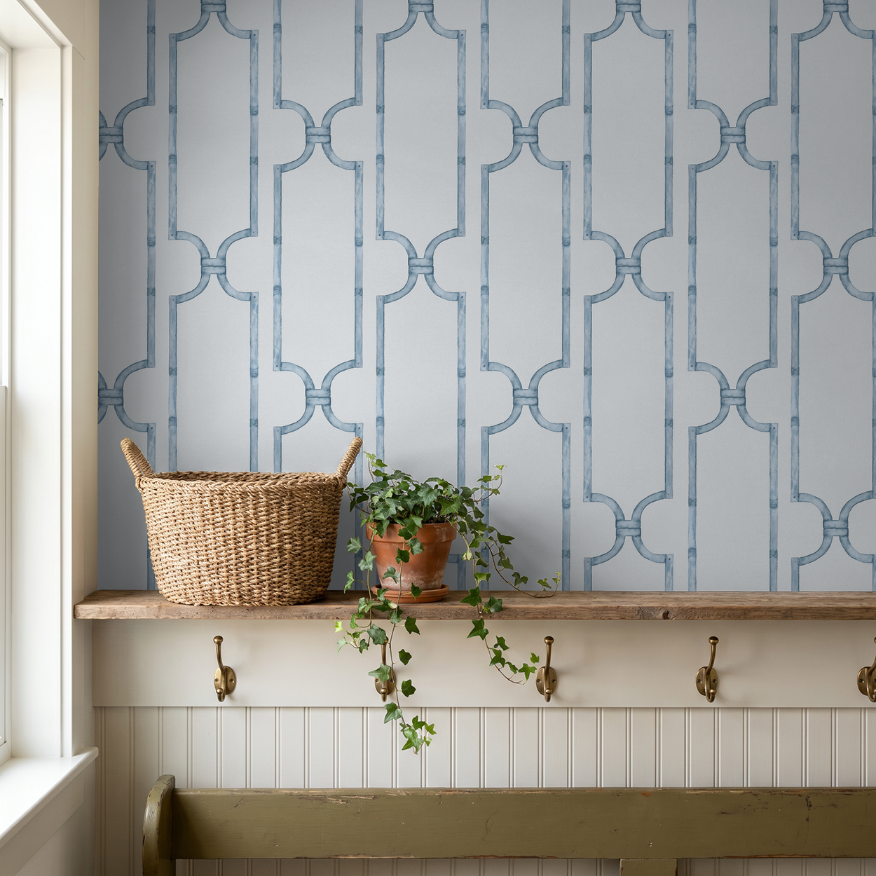 Blue trellis wallpaper in cozy room with shelf and plant decor.