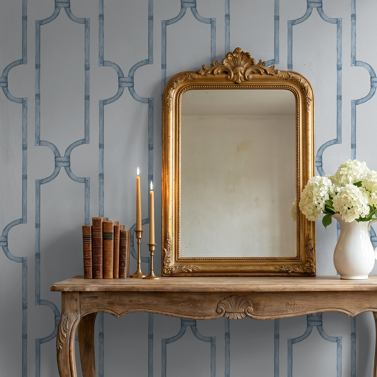 Elegant blue trellis wallpaper in classic room with ornate mirror and flowers.