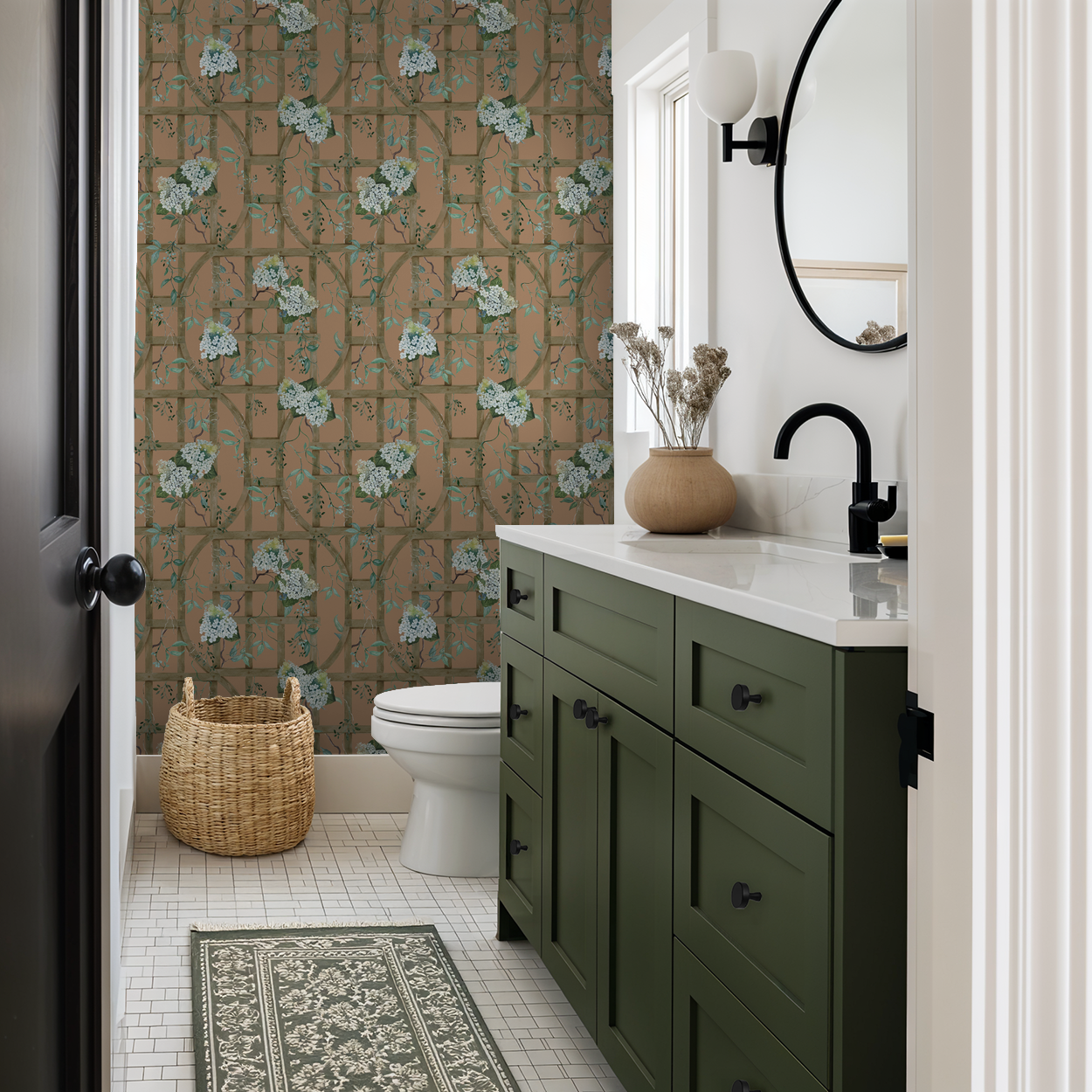Burnt orange floral trellis wallpaper in bathroom with green vanity and wicker basket.