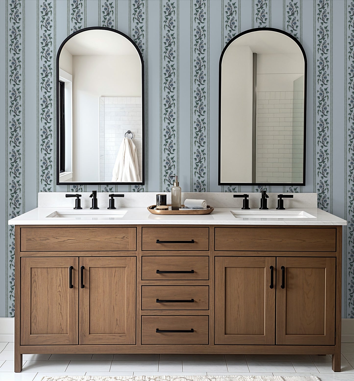 Bathroom with Chickadee Stripe Harbor Mist wallpaper, featuring soft blue stripes and floral motifs.