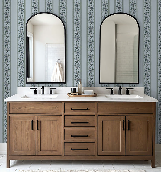 Bathroom with Chickadee Stripe Harbor Mist wallpaper, featuring soft blue stripes and floral motifs.