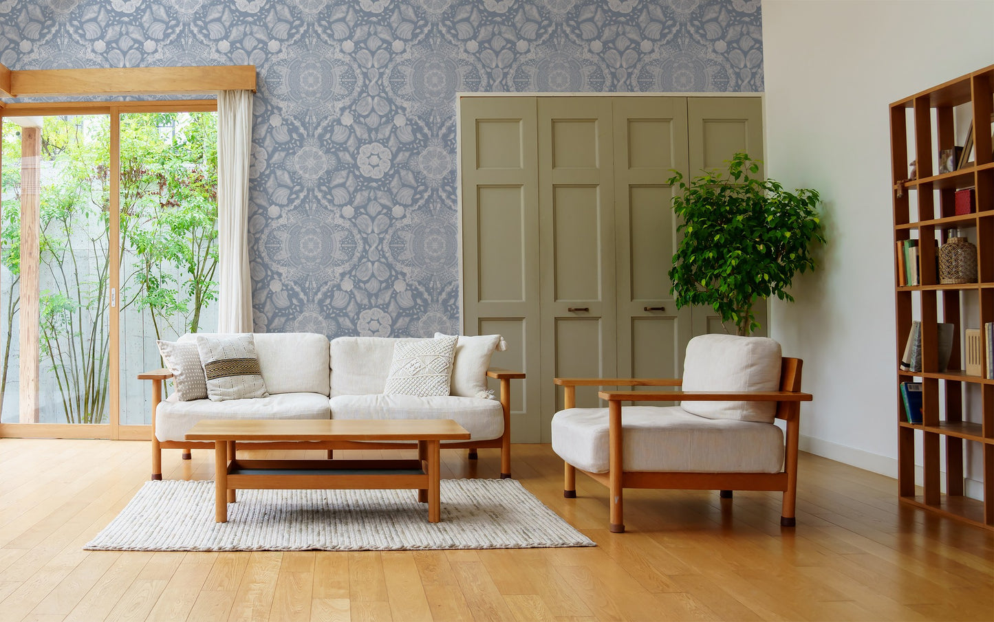 Coastal lace wallpaper with shell motifs in a modern living room setting.