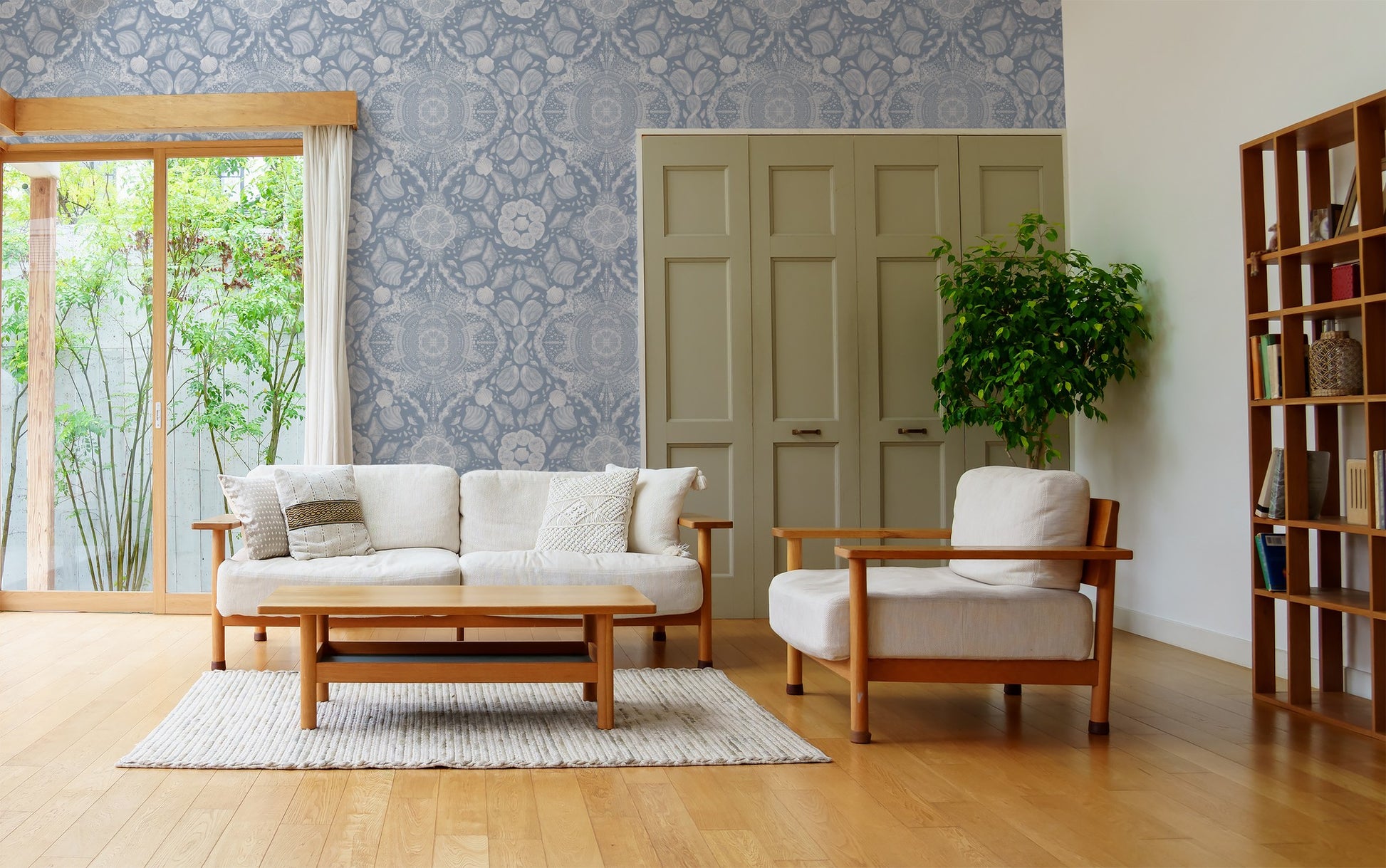 Coastal lace wallpaper with shell motifs in a modern living room setting.