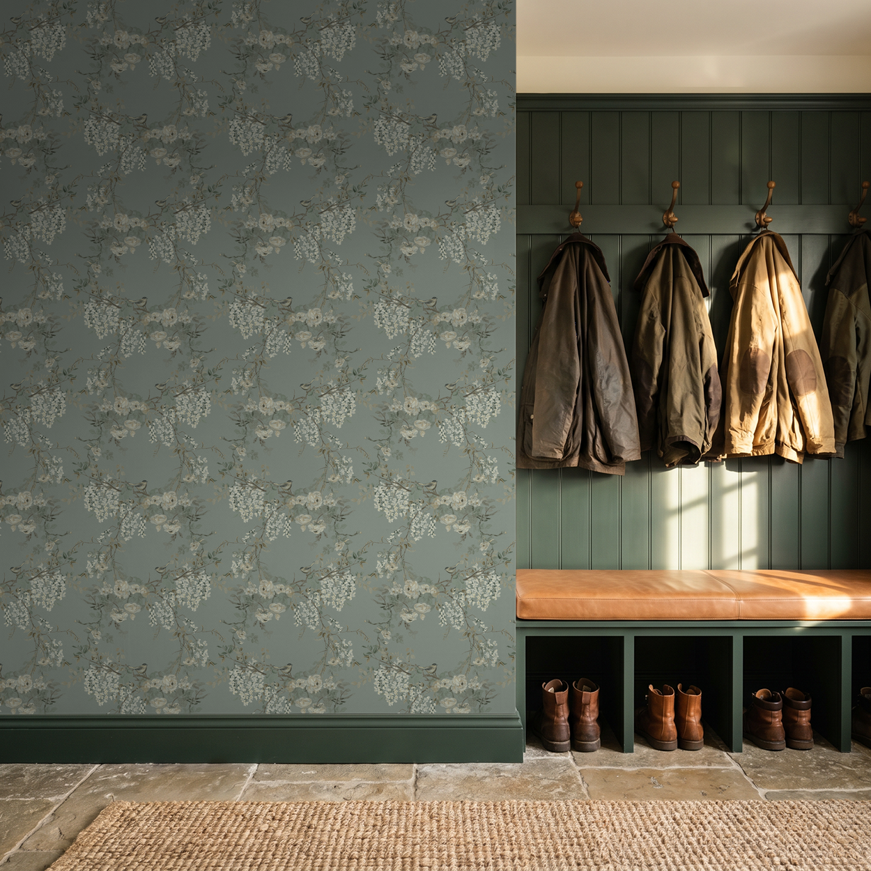 Cream and sage floral wallpaper in a cozy entryway with coats and boots.