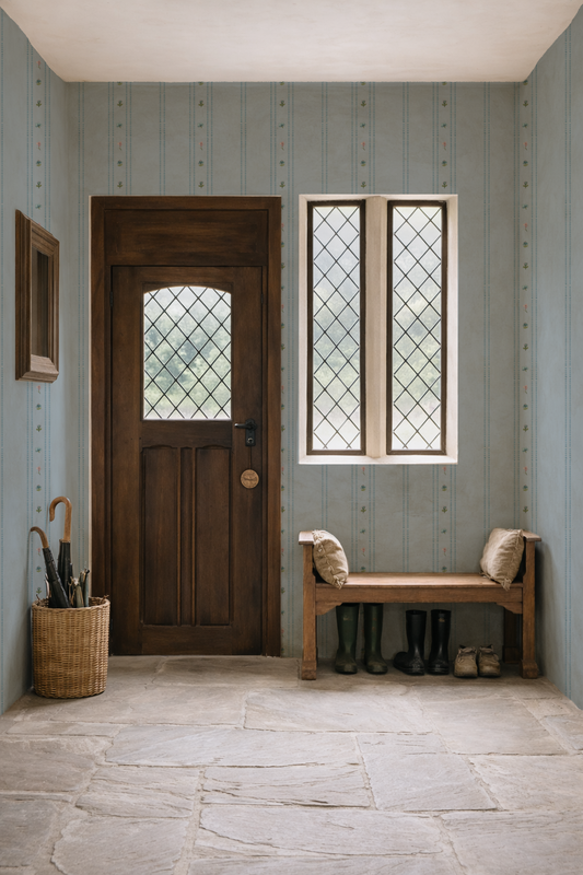 Foyer with wooden door, bench, and patterned wallpaper