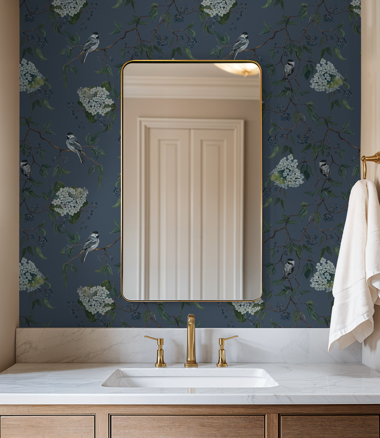 Deep blue wallpaper with birds and blooms in elegant bathroom setting.